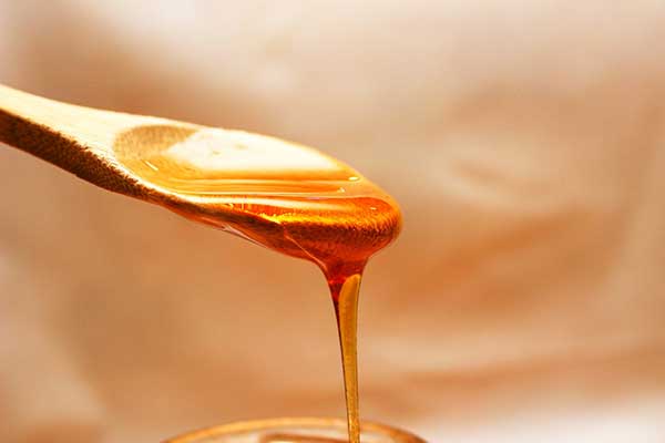 honey flowing from spoon